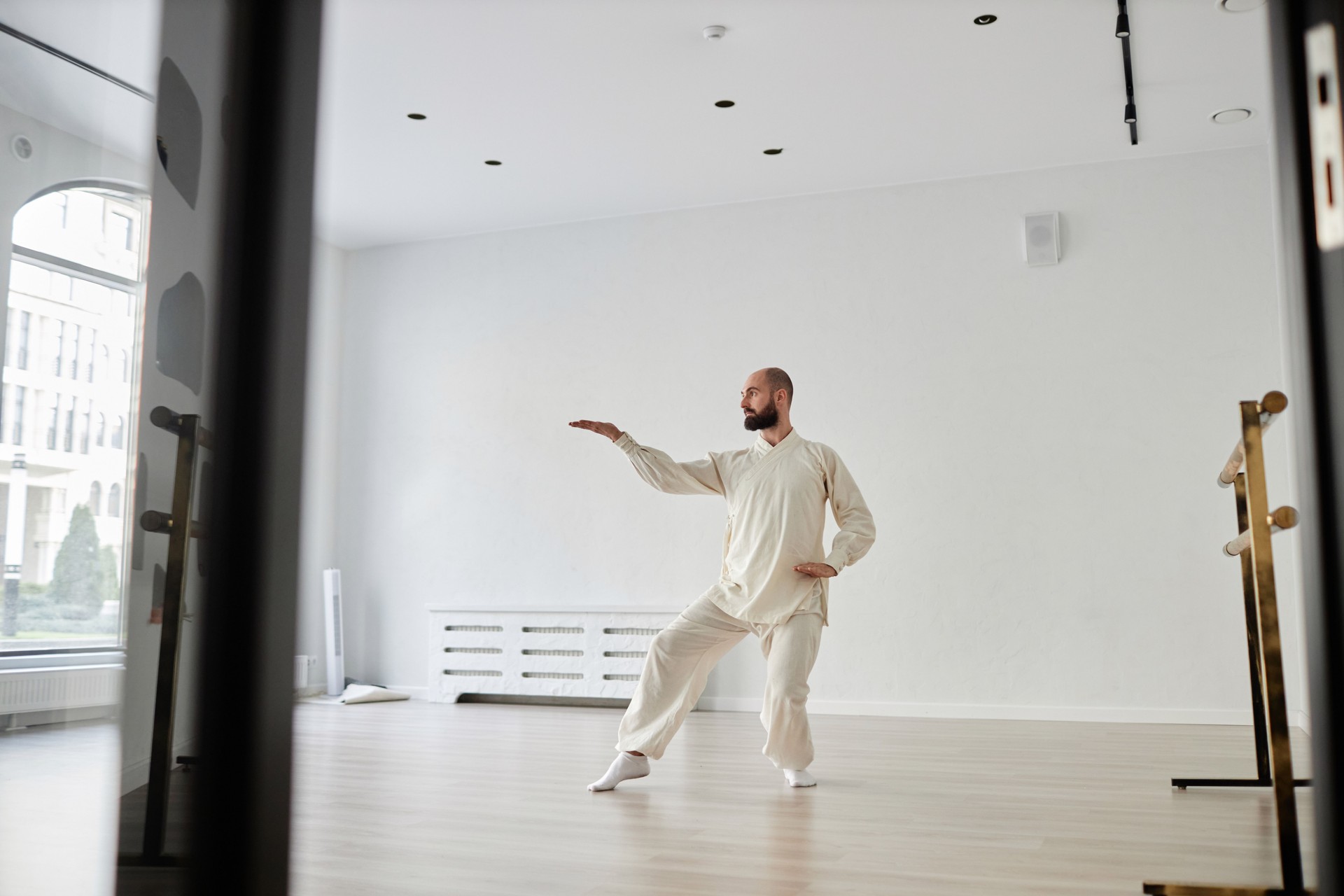 Trainer Warming up before Qigong Class in Fitness Studio